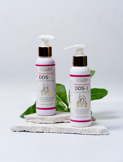 A white bottle of DDS-1 premium intimate cleanser with a clean leaf in the background.