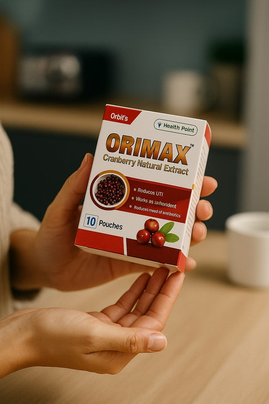 Woman holding Orimax cranberry sachet product for daily urinary health